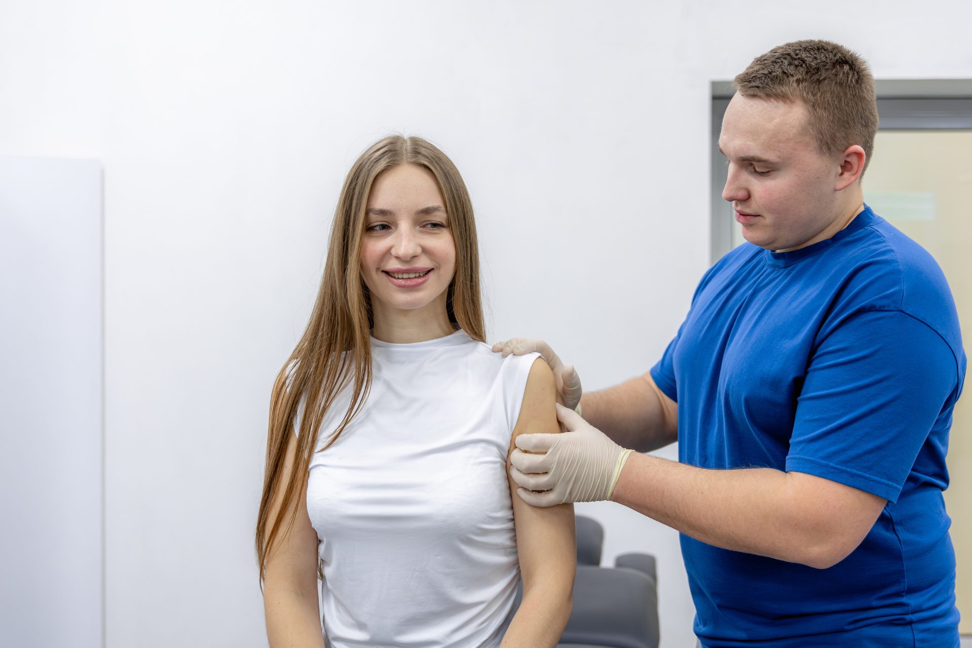 Patient receiving a medical injection from a healthcare professional in a clinical setting, illustrating advanced pain management services at Allevia Centers.